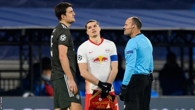 Marcel Sabitzer (centre) of RB Leipzig with Manchester United's Harry Maguire before a Champions League game